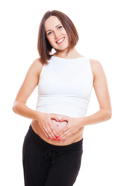 Mulher grávida mostrando os dedos como coração — Fotografia de Stock