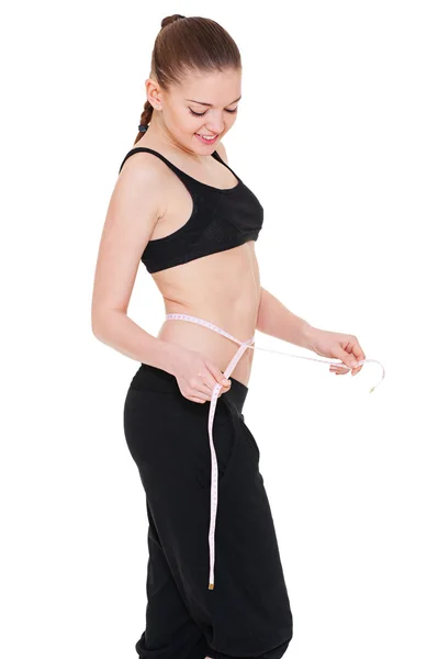 Mulher magra saudável medindo sua cintura — Fotografia de Stock