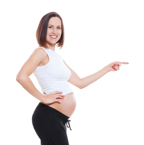 Smiley mulher grávida apontando para algo — Fotografia de Stock
