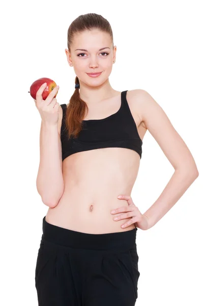 Woman in sportswear holding red apple — Stok fotoğraf