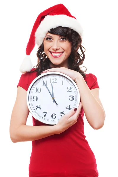 Mädchen mit Weihnachtsmütze hält Uhr — Stockfoto