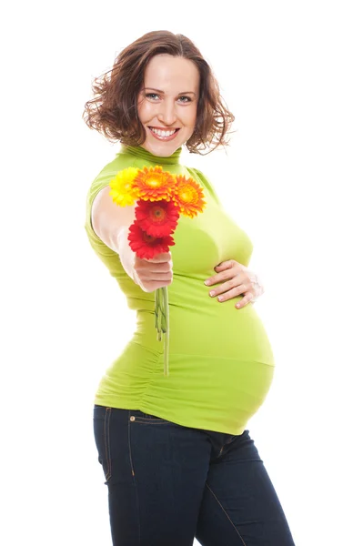 Glad pregnant woman with flowers — Stock Photo, Image