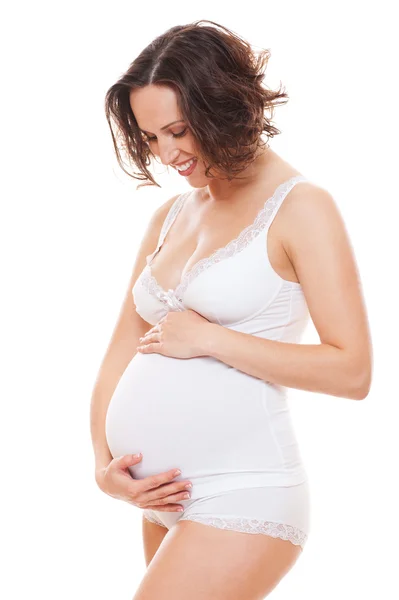 Happy woman looking on her belly — Stock Photo, Image