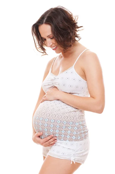 Zwangere vrouw op zoek op haar buik — Stockfoto