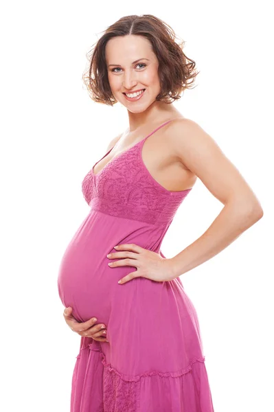 Kobieta w ciąży dość w sukienkę różowy — Zdjęcie stockowe