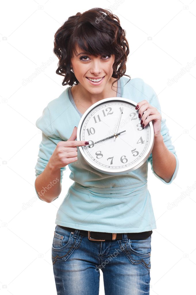 Young woman pointing at clock