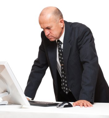 Serious businessman looking at monitor clipart