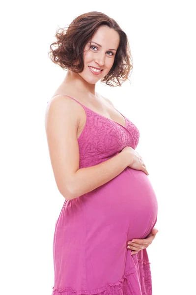 Kobieta w ciąży dość w sukienkę różowy — Zdjęcie stockowe