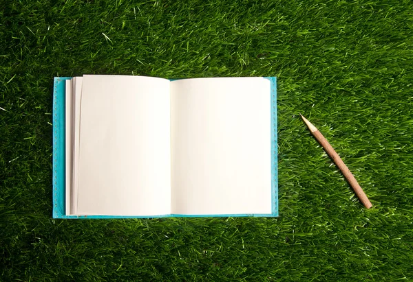 Notebook in the grass — Stock Photo, Image