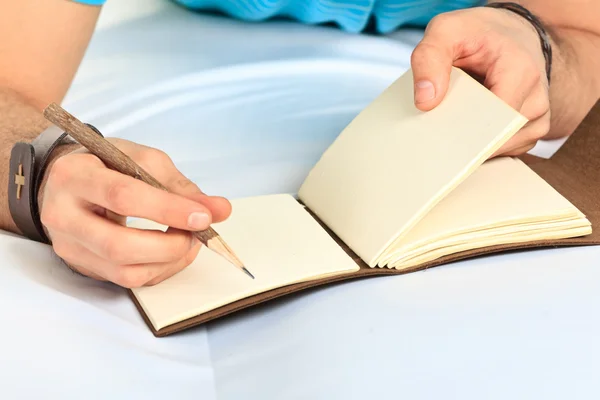 Hand and notebook. Close up — Stock Photo, Image