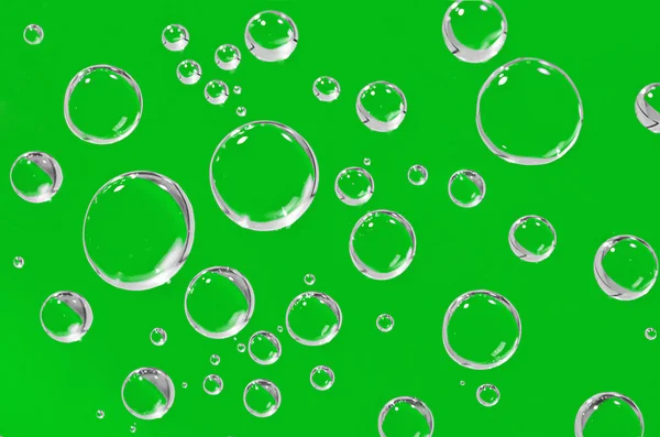 Water droplets on a green background. — Stock Photo, Image