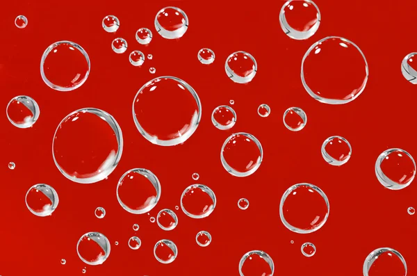 Water droplets on a red background. — Stock Photo, Image