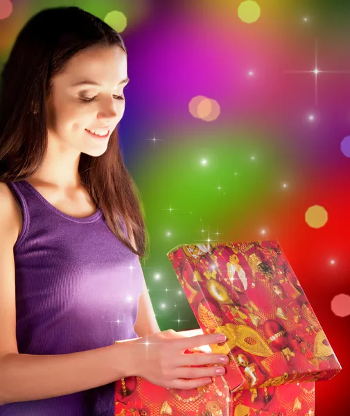 The girl opens the gift Stock Image
