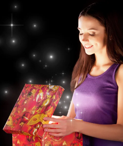 Stock image The girl opens the gift