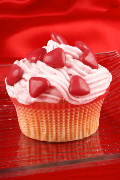 Cupcake with red sugar-coated hearts — Stock Photo, Image