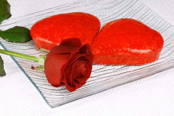 Two red heart shaped cakes and a rose — Stock Photo, Image