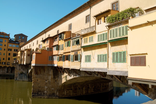 Ponte Vecchio (old bridge) on river Arno in Florence. This medieval stone arch bridge is very well known for its jewellers shops constructed on it.