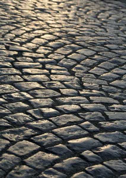 Close-up of the old pavement stones in dark colors — Stock Photo, Image