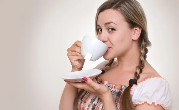 Dívka pití čaje z poháru. — Stock fotografie