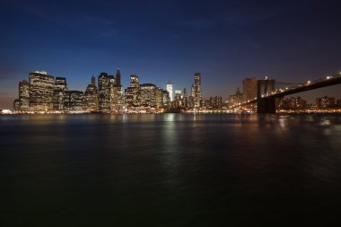 The New York City skyline w Brooklyn Bridge clipart