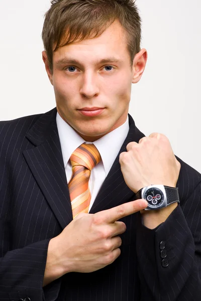 Angry young businessman showing time — Stock Photo, Image