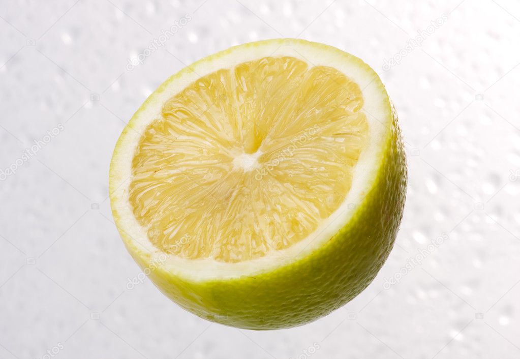 Lemon on dewy background