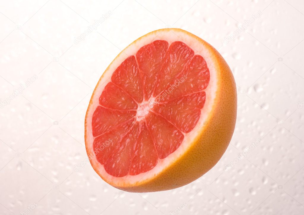 Fresh grapefruit on dewy background