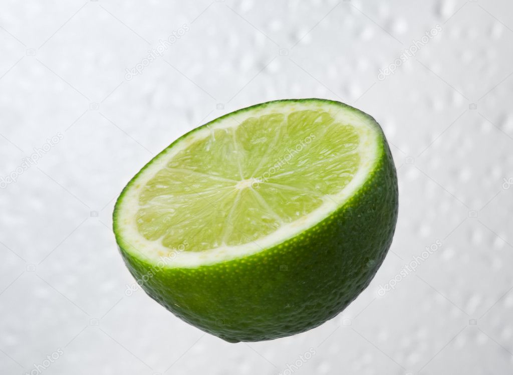 Green lime fruit on dewy background