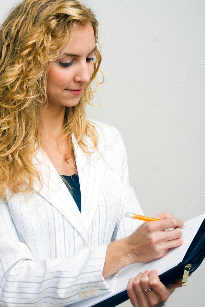 Young secretary making notes