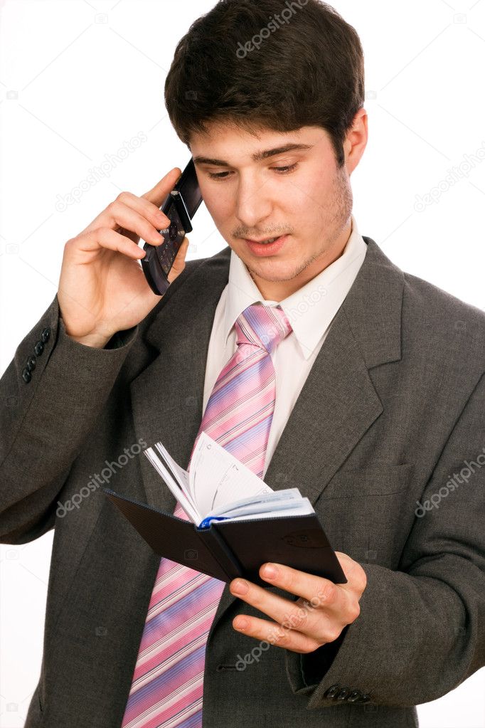 Young businessman with phone and diary