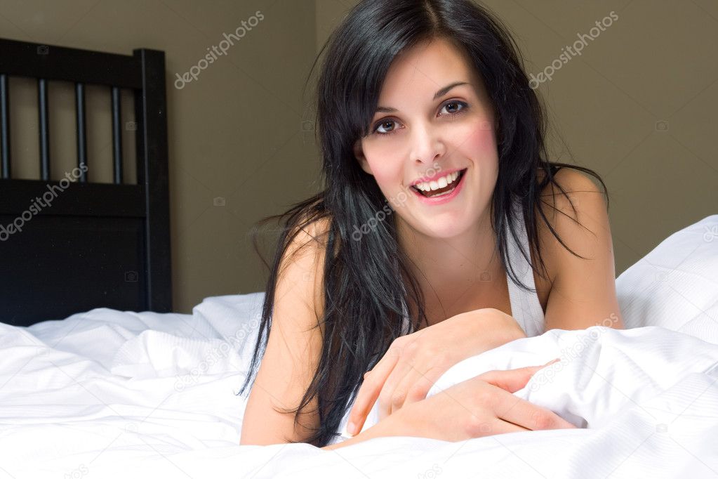 Portrait of beautiful woman on bed