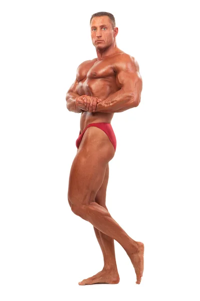 Bodybuilder masculin démontrant pose, isolé — Photo