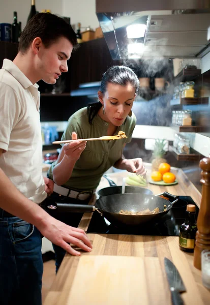 Νεαρό ζευγάρι στην κουζίνα προετοιμασία του γεύματος — Φωτογραφία Αρχείου