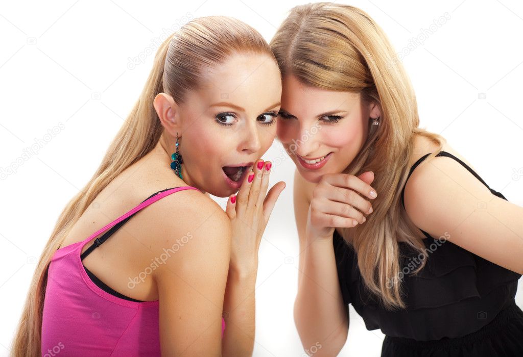 Two young woman wispering secrets