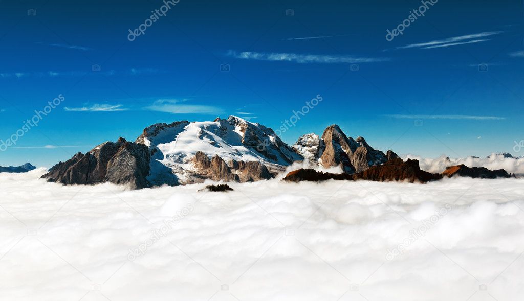 Marmolada - mountain peak emerges from the clouds
