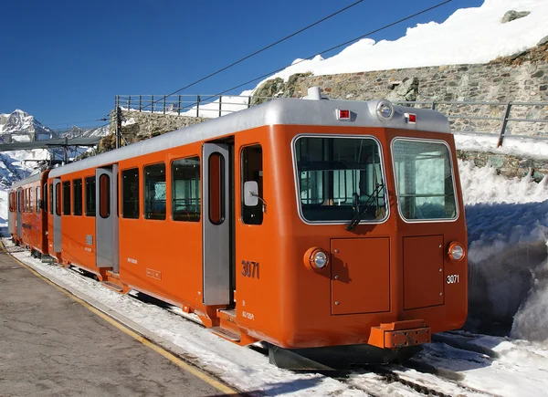 stock image Train at railway station in Alps.