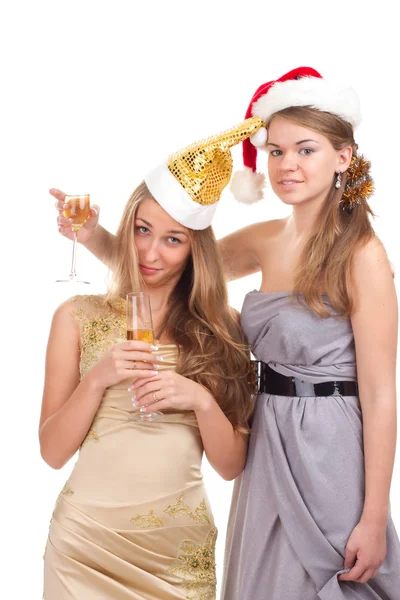 Two girls celebrate Christmas with gifts and glasses in their hands — Stock Photo, Image
