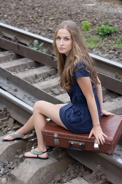 Woman sitting on rails — Zdjęcie stockowe