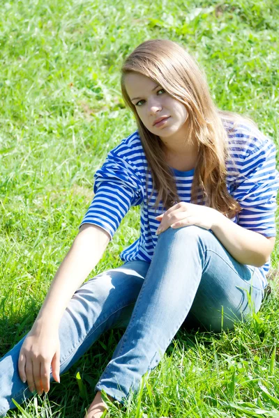 Beautiful girl in the shirt on the grass — Stock Photo, Image