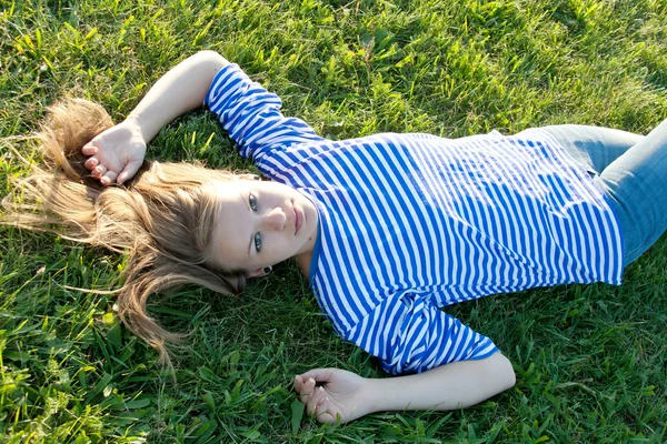 Beautiful girl in the shirt on the grass — Stock Photo, Image