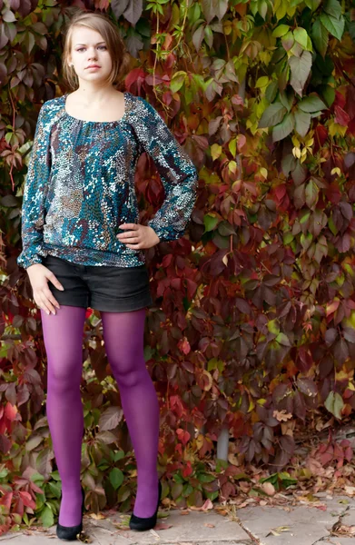 Beautiful girl in purple tights in autumn — Stock Photo, Image