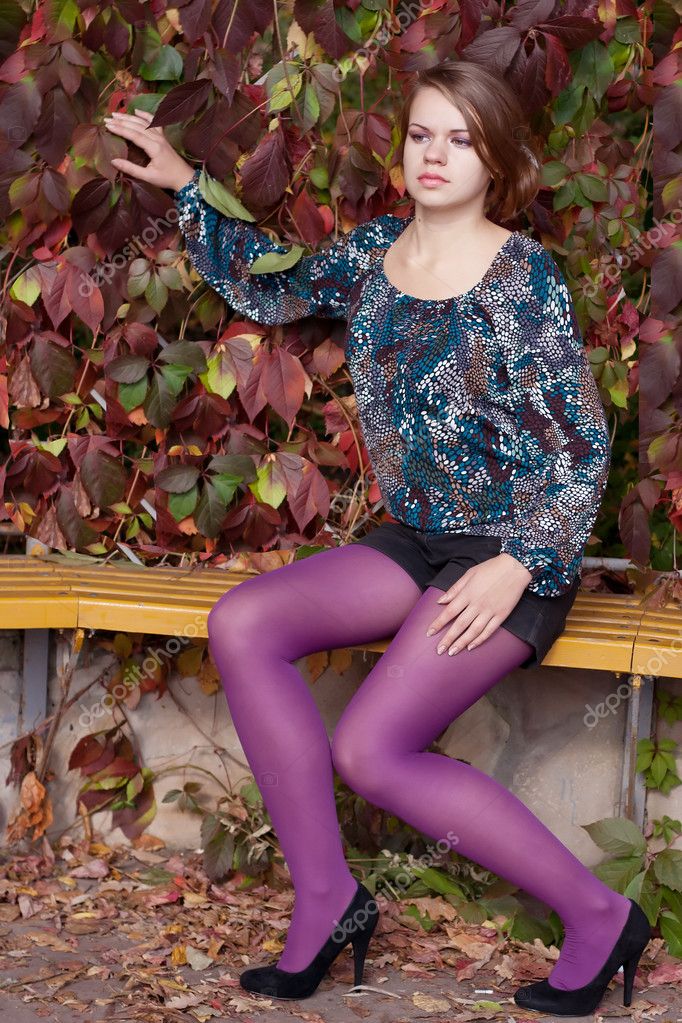 Beautiful girl in purple tights in autumn Stock Photo by