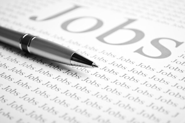 Pen and a sheet of paper with text on job search