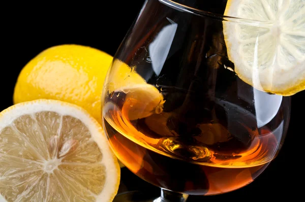 Cognac with lemon in a classic glass — Stock Photo, Image