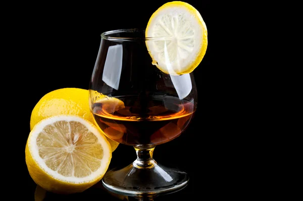 Cognac with lemon in a classic glass — Stock Photo, Image