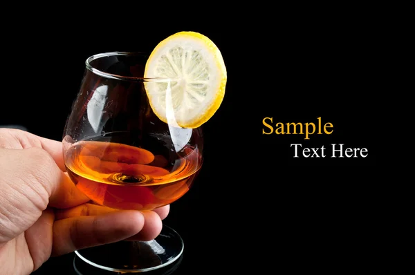 Stock image Cognac with lemon in hand