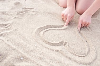 Girl draws a heart