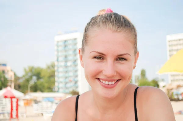 Młoda kobieta uśmiechając się na plaży — Zdjęcie stockowe