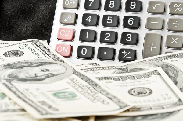 Calculator and many dollars — Stock Photo, Image
