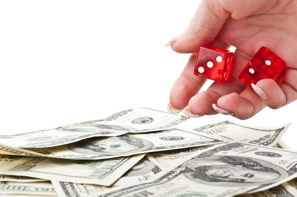 Girl throws the dice on dollars — Stock Photo, Image